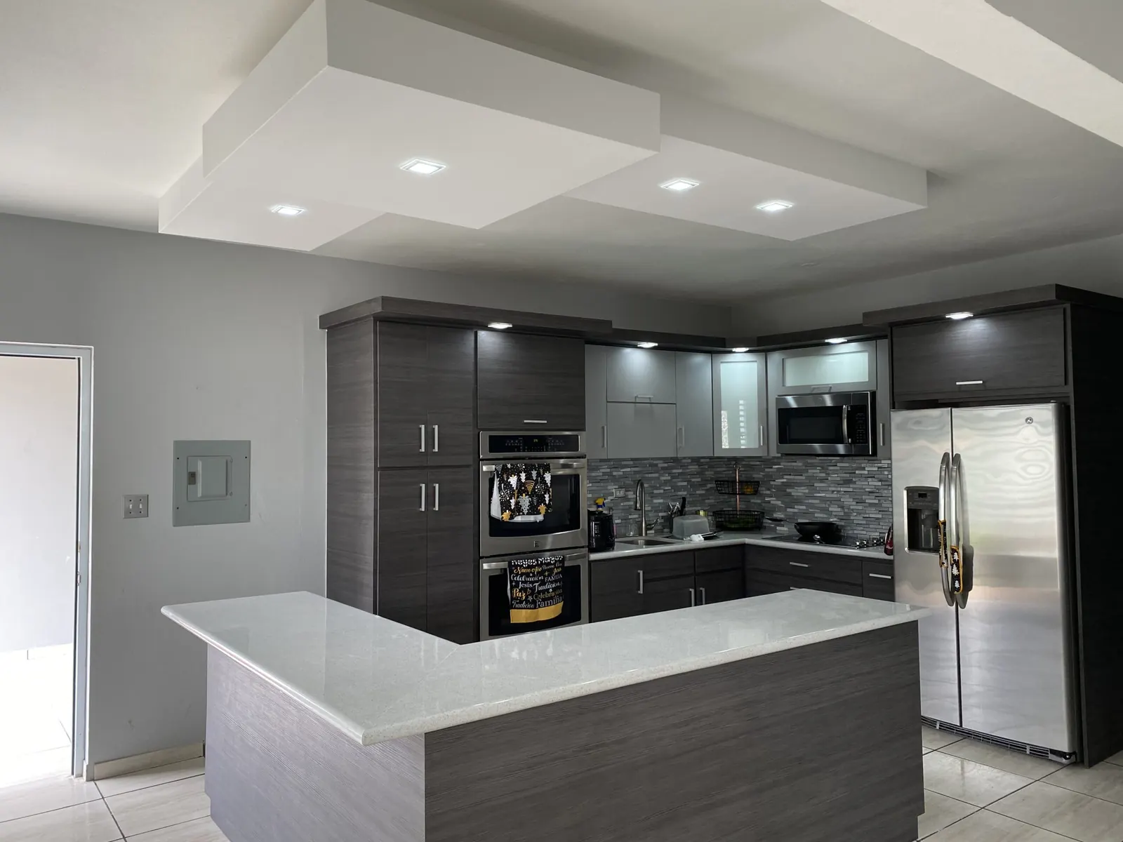 Kitchen remodel with a layered fascia ceiling and recessed lights